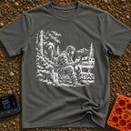 Meet The Locals - T-Shirt in Pepper - A black and white illustration of a man sitting by a campfire looking at his...