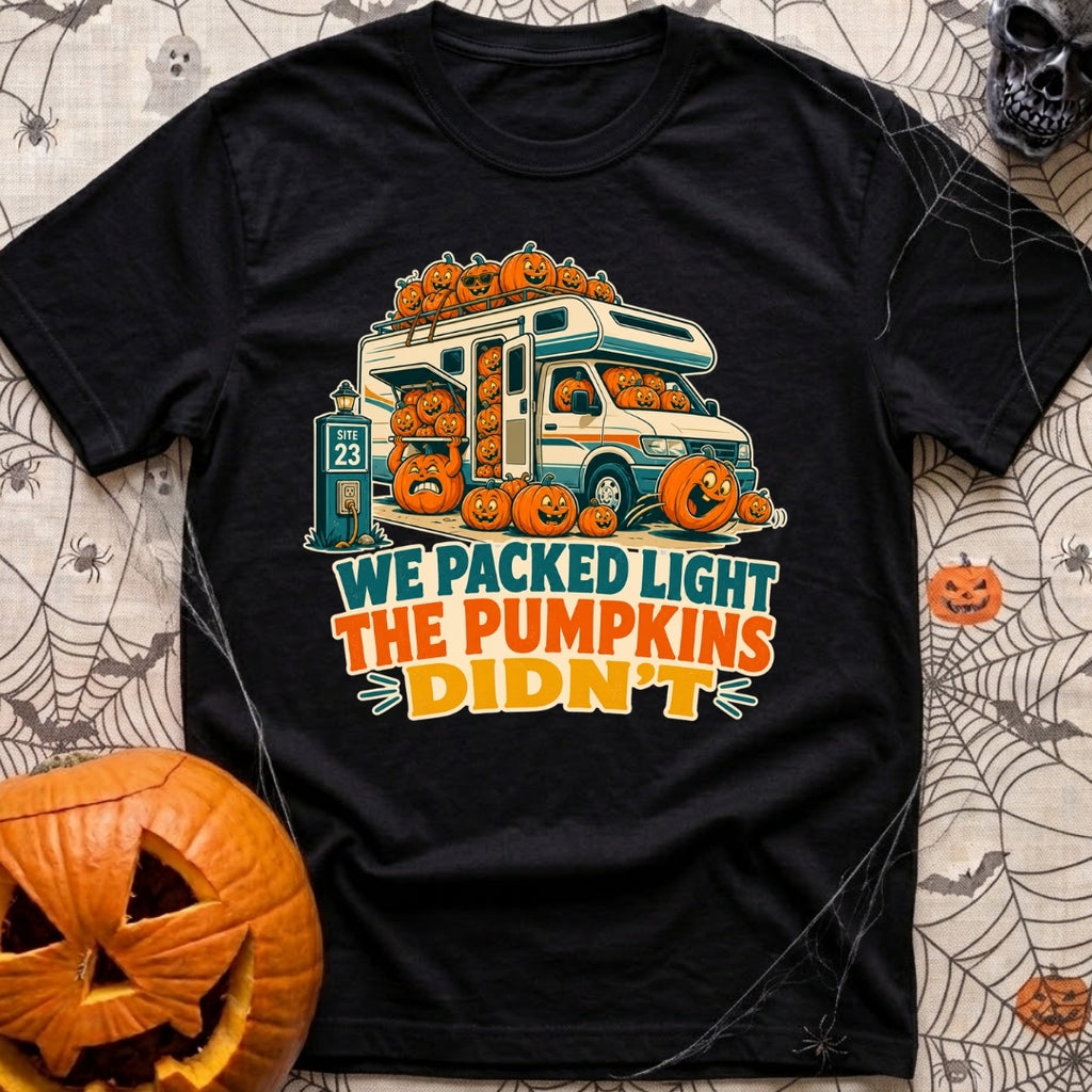 Packed Light Except Pumpkins - T-Shirt in Black - A cartoon motorhome parked at a campsite hookup labeled "Site 23",...