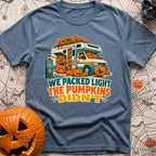 Packed Light Except Pumpkins - T-Shirt in Blue Jean - A cartoon motorhome parked at a campsite hookup labeled "Site 23",...