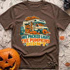 Packed Light Except Pumpkins - T-Shirt in Espresso - A cartoon motorhome parked at a campsite hookup labeled "Site 23",...