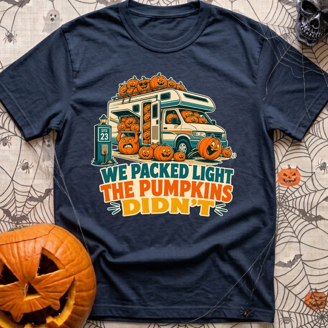 Packed Light Except Pumpkins - T-Shirt in Navy - A cartoon motorhome parked at a campsite hookup labeled "Site 23",...