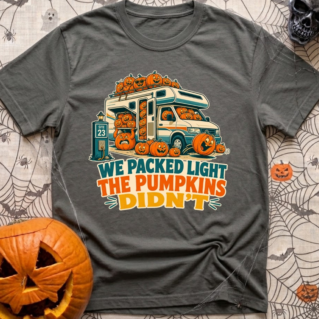 Packed Light Except Pumpkins - T-Shirt in Pepper - A cartoon motorhome parked at a campsite hookup labeled "Site 23",...