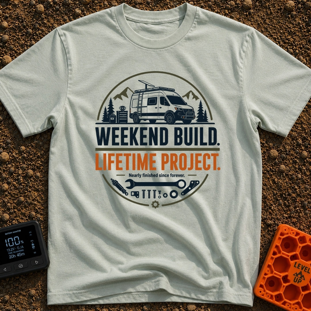 Lifetime Weekend Build - T-Shirt in Bay - A circular graphic showing a white camper van parked near pine trees and...