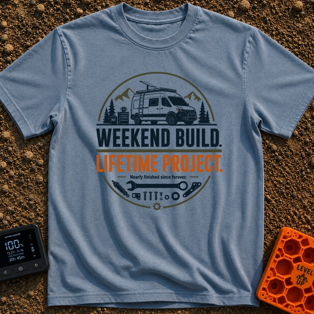 Lifetime Weekend Build - T-Shirt in Blue Jean - A circular graphic showing a white camper van parked near pine trees and...