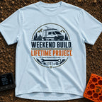 Lifetime Weekend Build - T-Shirt in Chambray - A circular graphic showing a white camper van parked near pine trees and...
