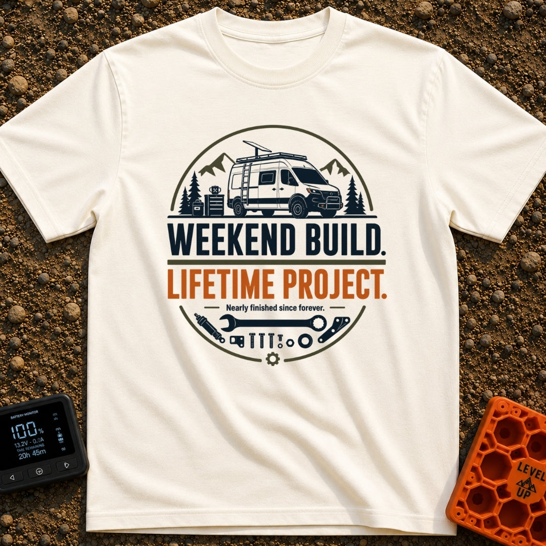 Lifetime Weekend Build - T-Shirt in Ivory - A circular graphic showing a white camper van parked near pine trees and...