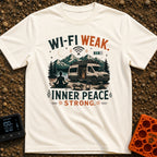 Low Signal High Zen - T-Shirt in Ivory - A silhouette of a woman meditating on a mat in front of a camper van with...