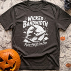Wicked Good Bandwidth - T-Shirt in Graphite - A distressed white graphic featuring a silhouette of a witch flying across...