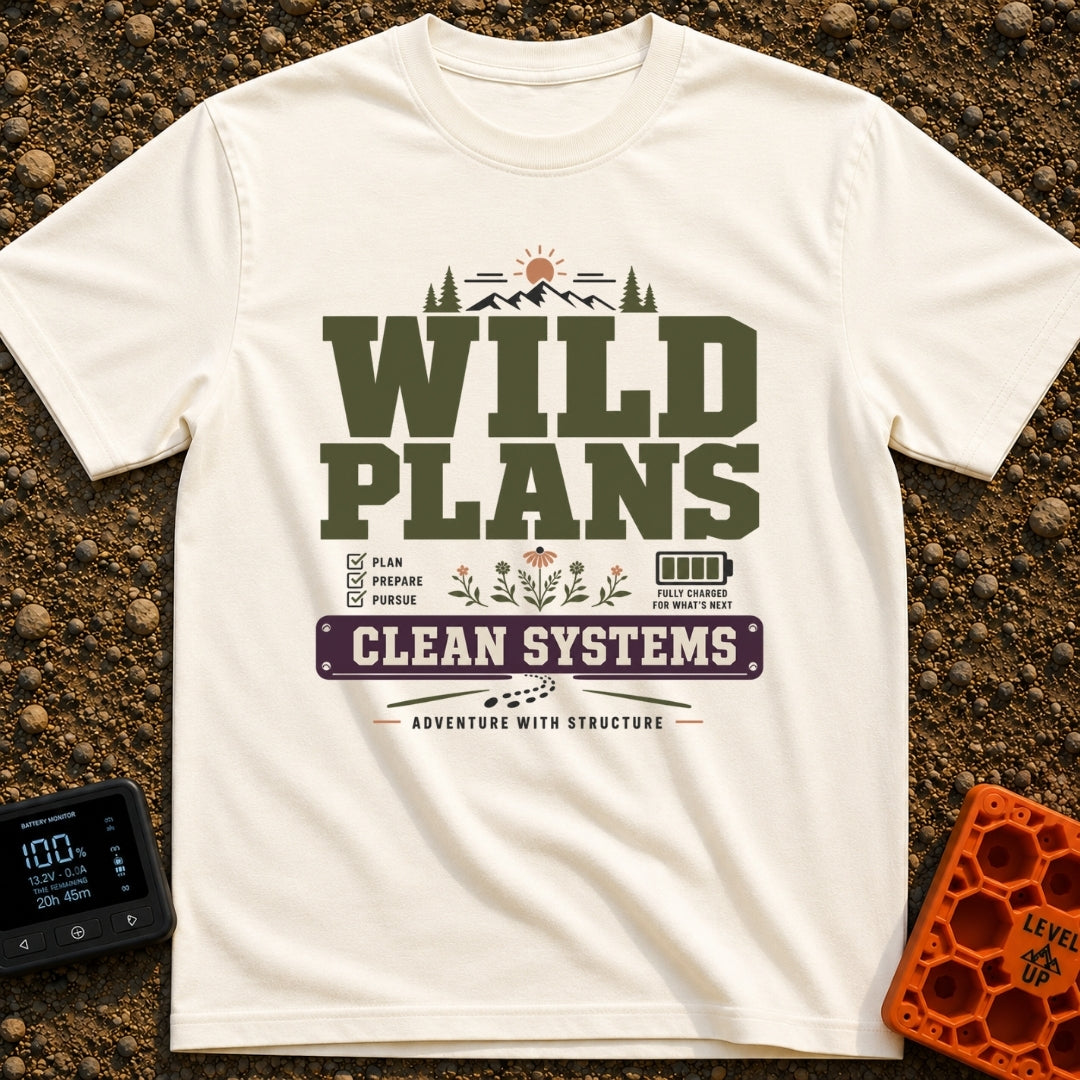 Wild Plans Clean Watts - T-Shirt in Ivory - A typographic design with the text "WILD PLANS" and "CLEAN SYSTEMS" alongside...