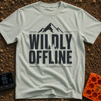 Wildly Off The Grid - T-Shirt in Bay - A typographic design featuring the large bold text "WILDLY OFFLINE" with pine tree...