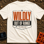 Wildly Out Of Range - T-Shirt in Ivory - A typographic badge design featuring the text 'WILDLY OUT OF RANGE' with...