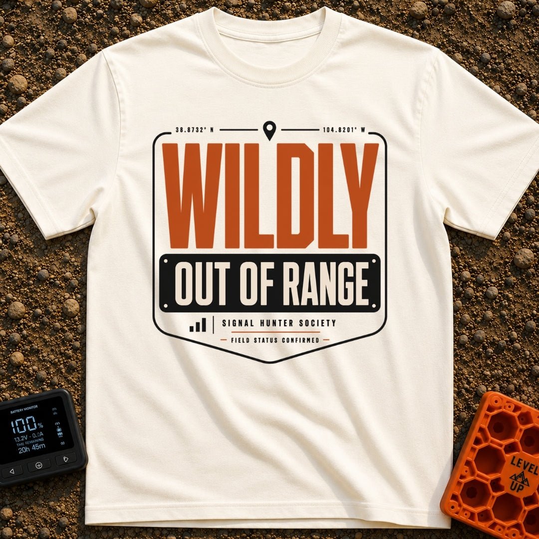 Wildly Out Of Range - T-Shirt in Ivory - A typographic badge design featuring the text 'WILDLY OUT OF RANGE' with...