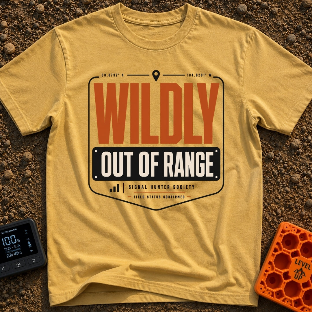 Wildly Out Of Range - T-Shirt in Mustard - A typographic badge design featuring the text 'WILDLY OUT OF RANGE' with...