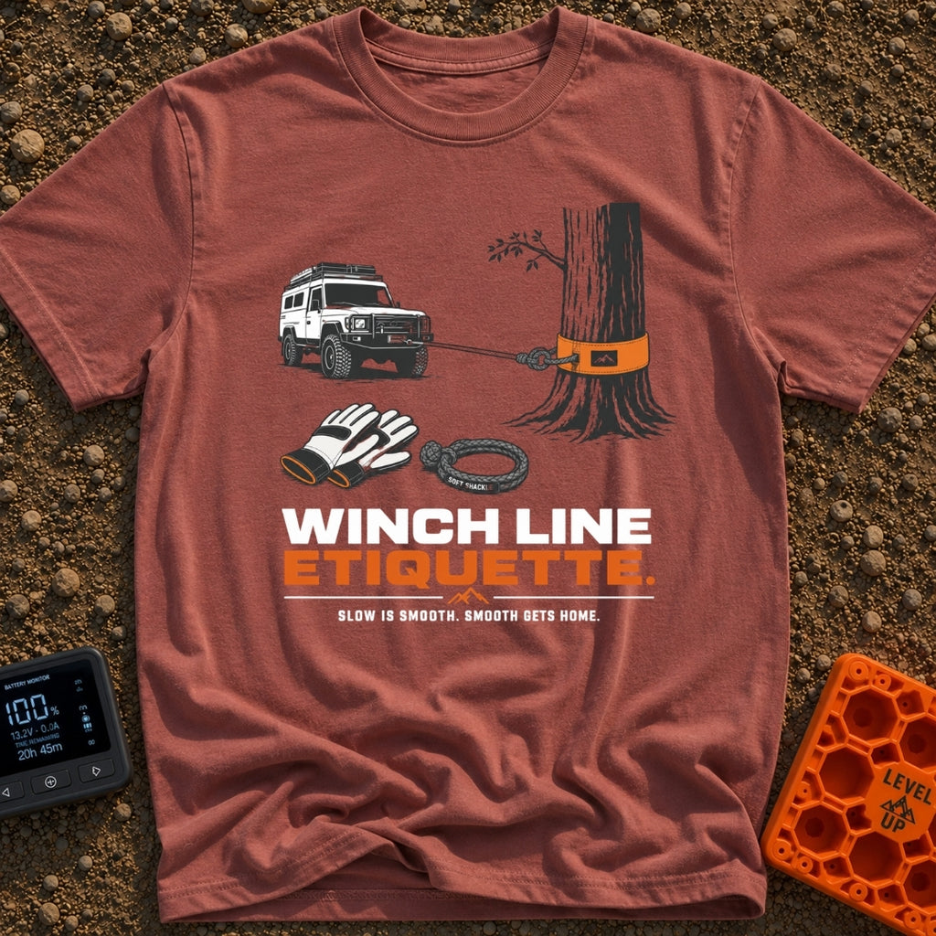 Mind Your Line - T-Shirt in Brick - An illustration of a white 4x4 SUV using a front winch attached to a tree with an...