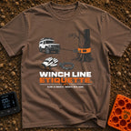 Mind Your Line - T-Shirt in Espresso - An illustration of a white 4x4 SUV using a front winch attached to a tree with an...