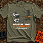 Mind Your Line - T-Shirt in Moss - An illustration of a white 4x4 SUV using a front winch attached to a tree with an...