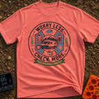 Overthinking Wanderlust Checklist - T-Shirt in Watermelon - A circular badge illustration featuring a white camper van...