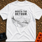 Worth The Detour - T-Shirt in White - A black and white line drawing of a camper van parked on a dirt pull-off...