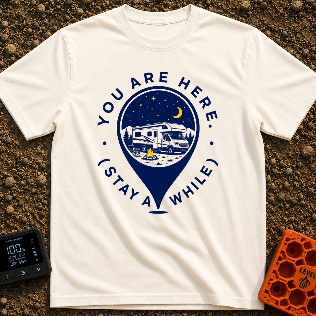 Stay Here A While - T-Shirt in Ivory - A graphic of a large location map pin containing an illustration of an RV parked...