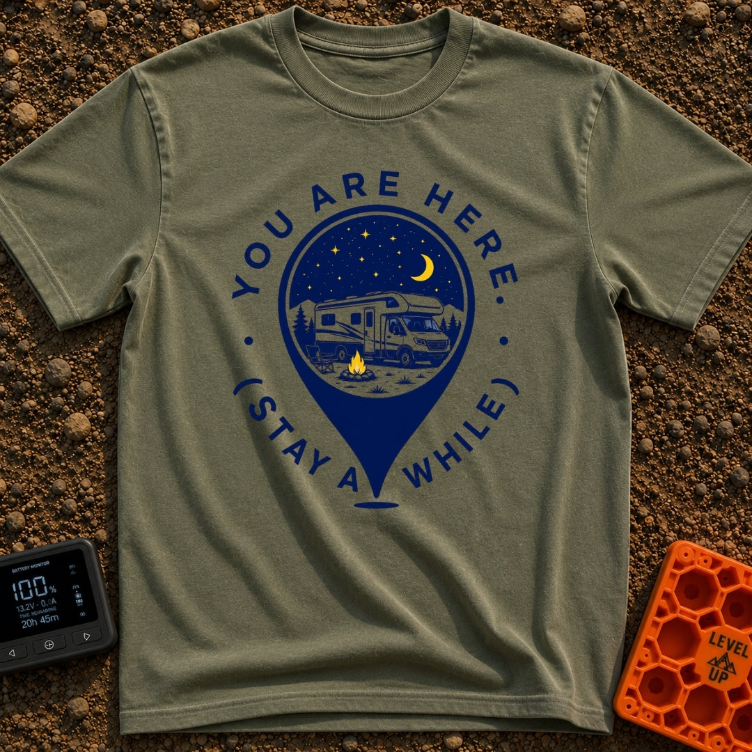 Stay Here A While - T-Shirt in Moss - A graphic of a large location map pin containing an illustration of an RV parked at...